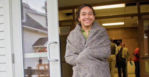 young woman in blanket