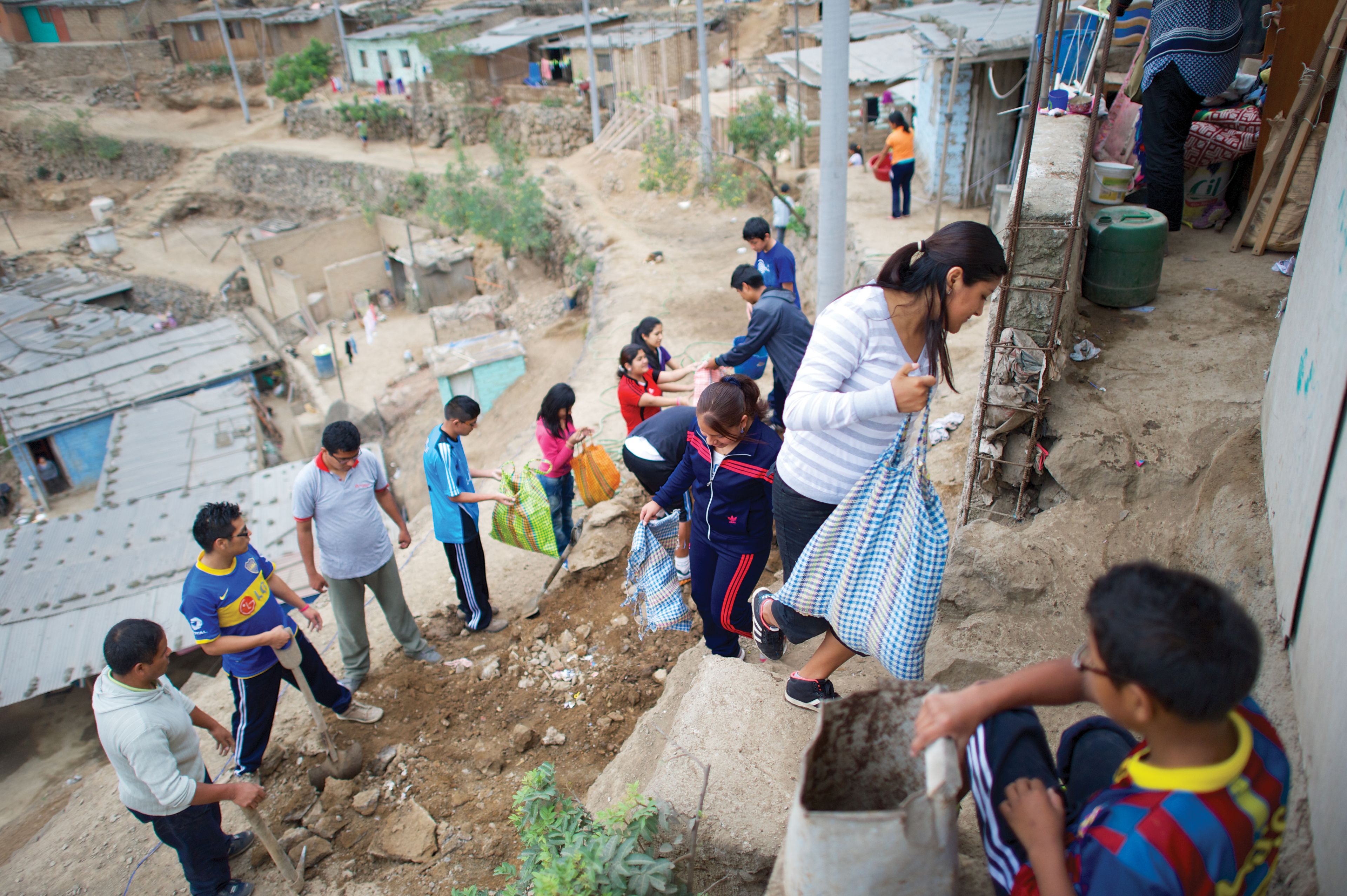 Youth help with a service project in Peru.