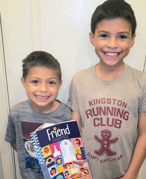 Gunnar and Nicolas Ward smile as they hold a Friend Magazine.