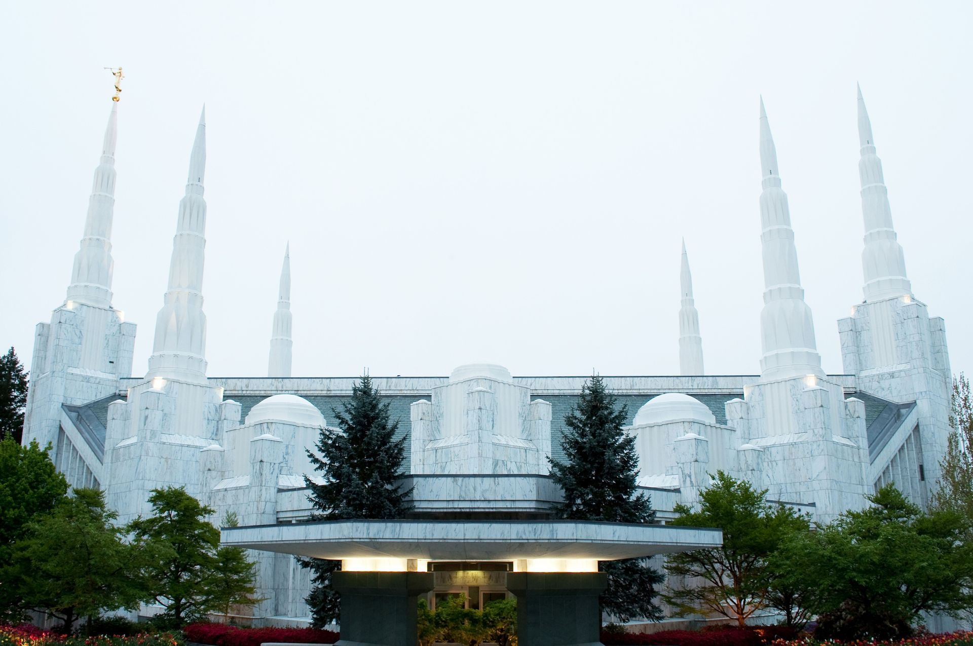 The Portland Oregon Temple and its entrance on a cloudy day.