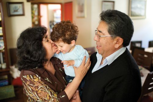Grandparents holding a small boy in Bolivia.
