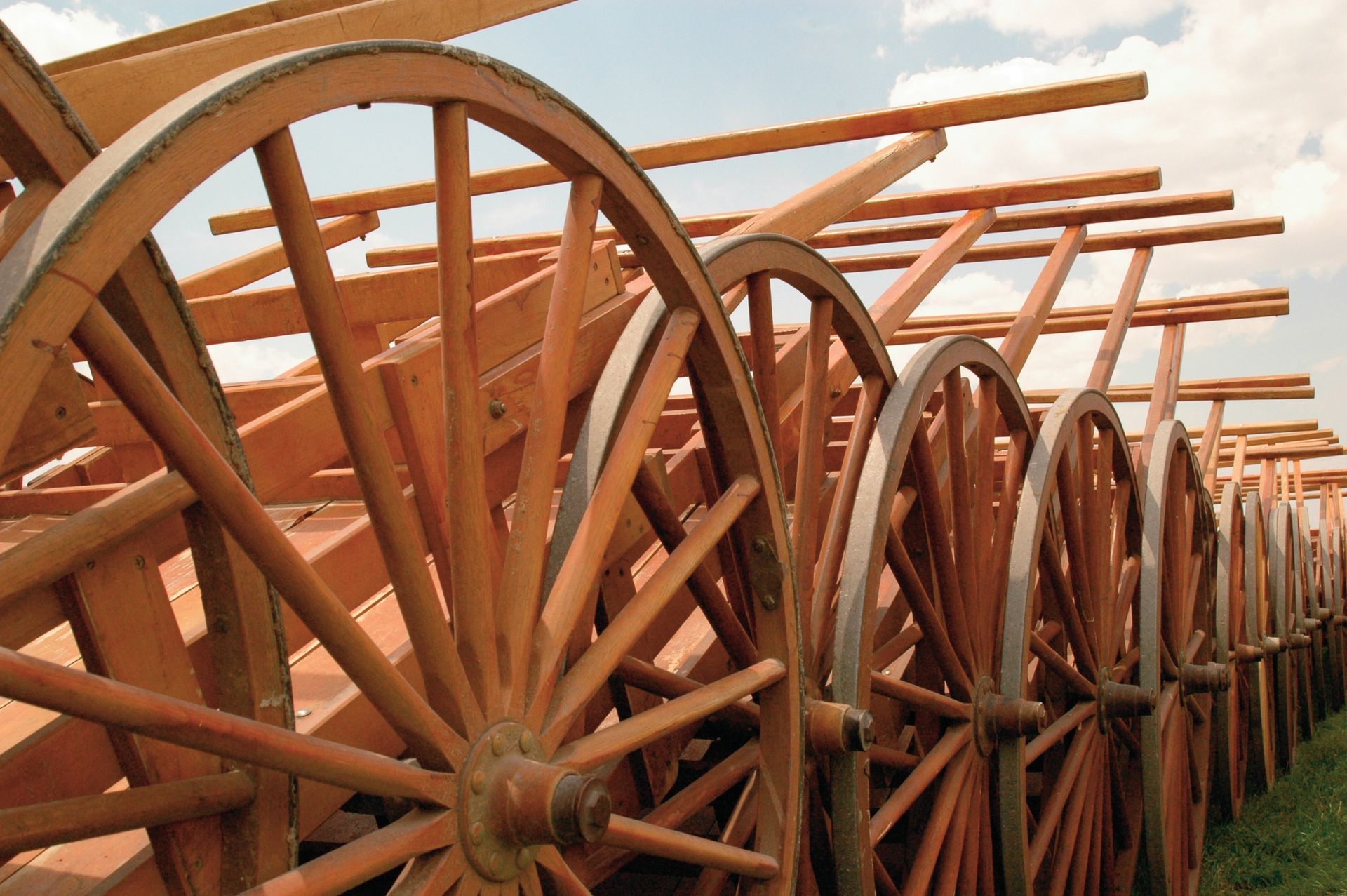 A group of wooden handcarts all lined up together.