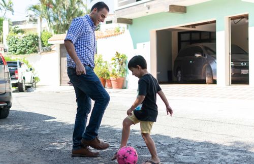 Father and son playing football