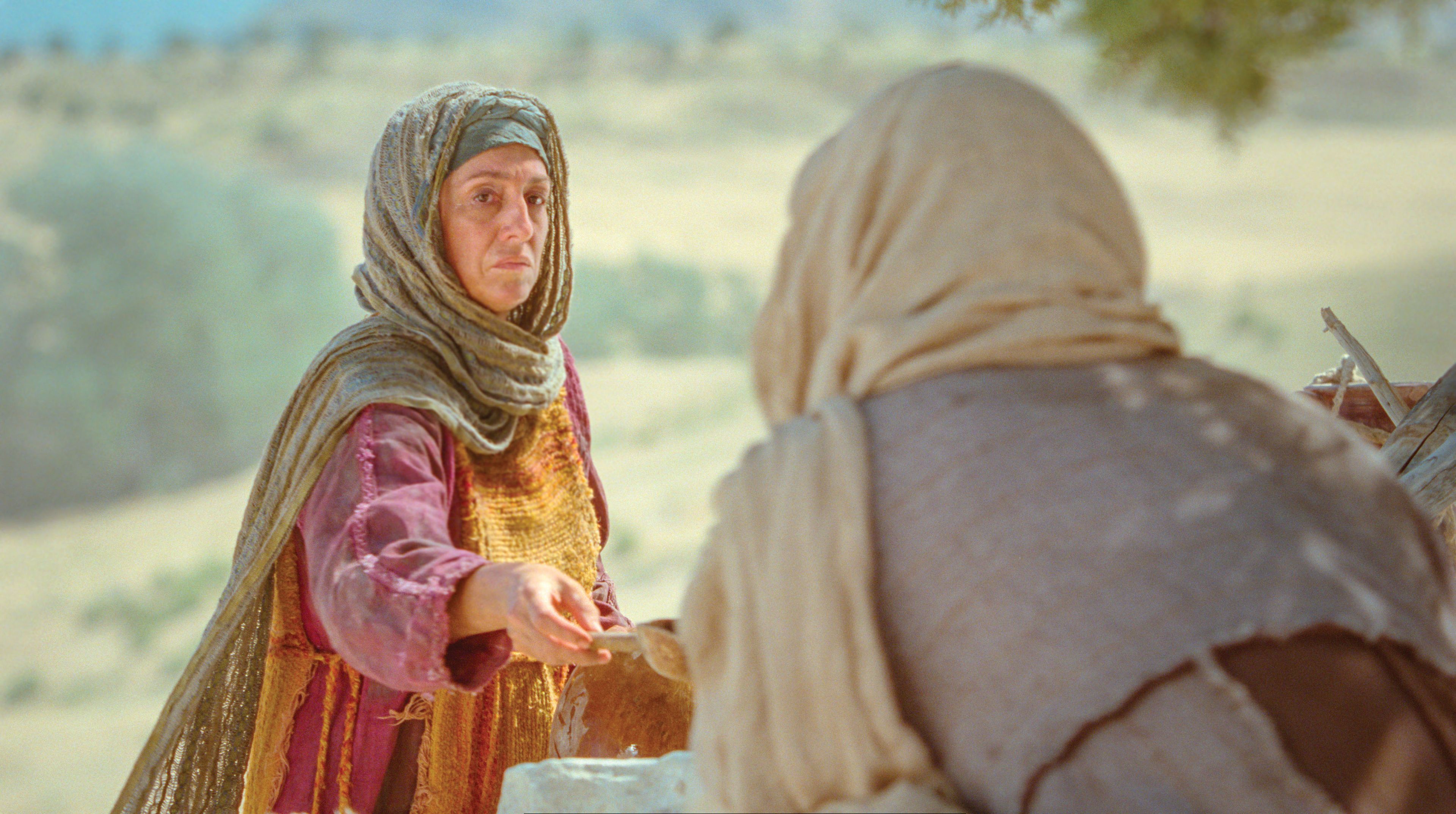 The Samaritan woman gives Jesus drink.