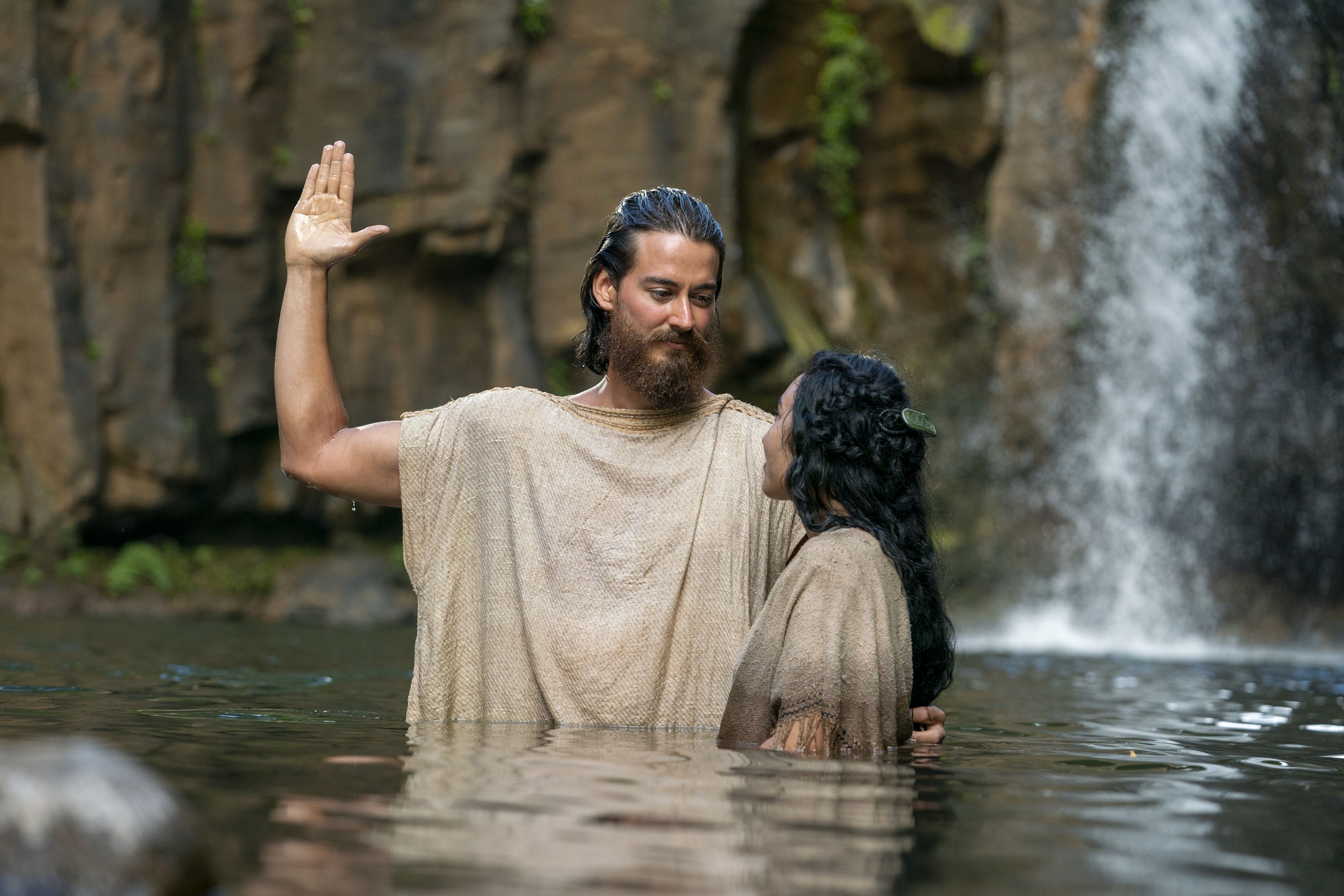 Alma baptizes people at the Waters of Mormon.