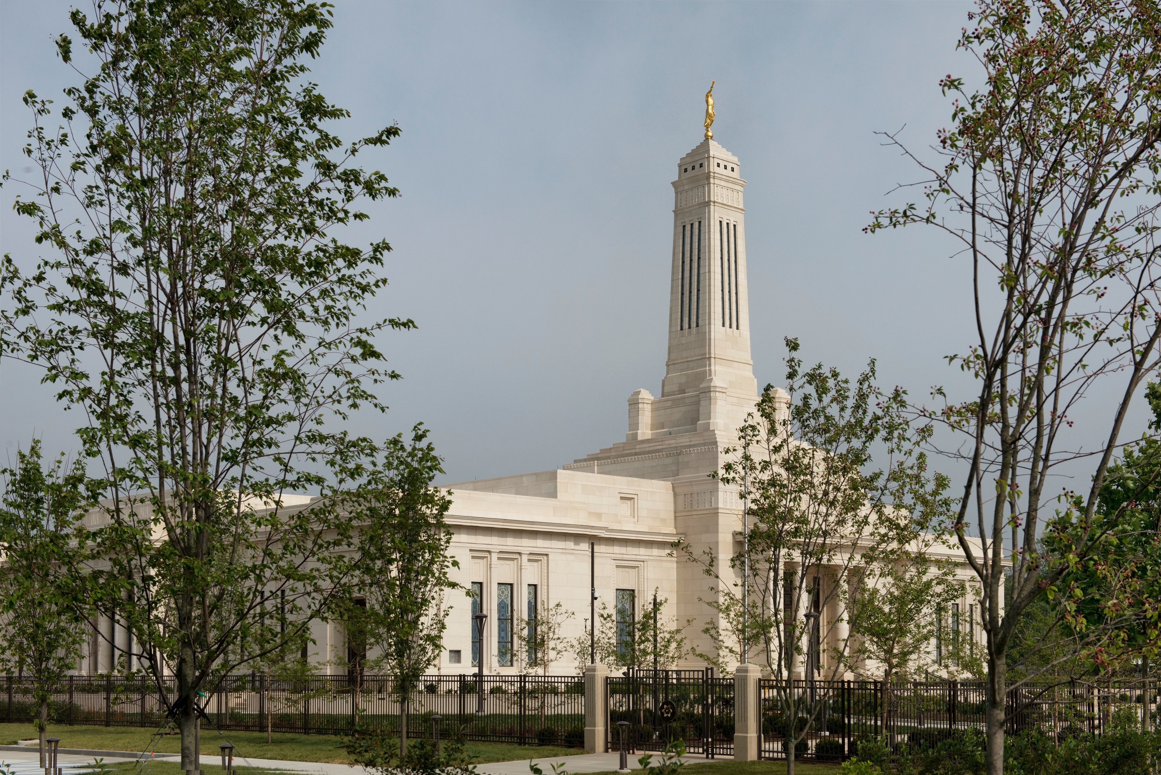 Trees in front of the Indianapolis Indiana Temple on a cloudy day.