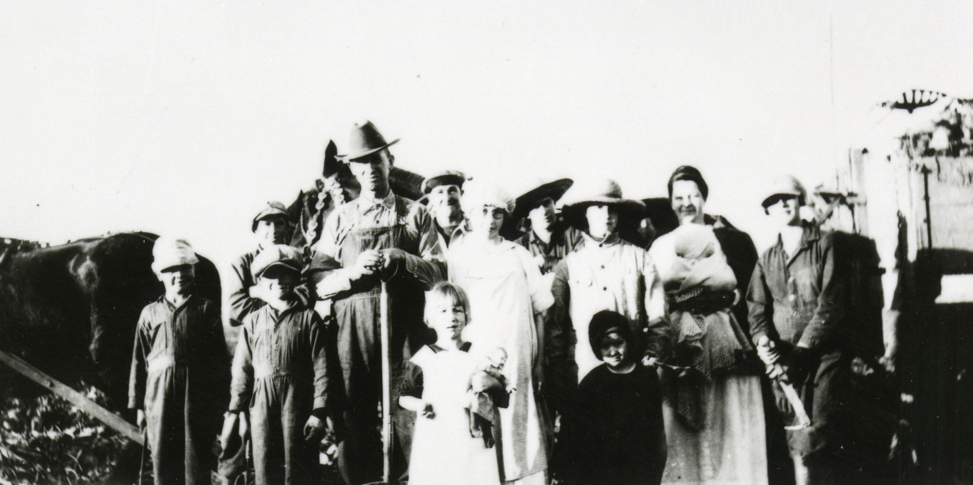 President Ezra Taft Benson standing with his family on their farm.