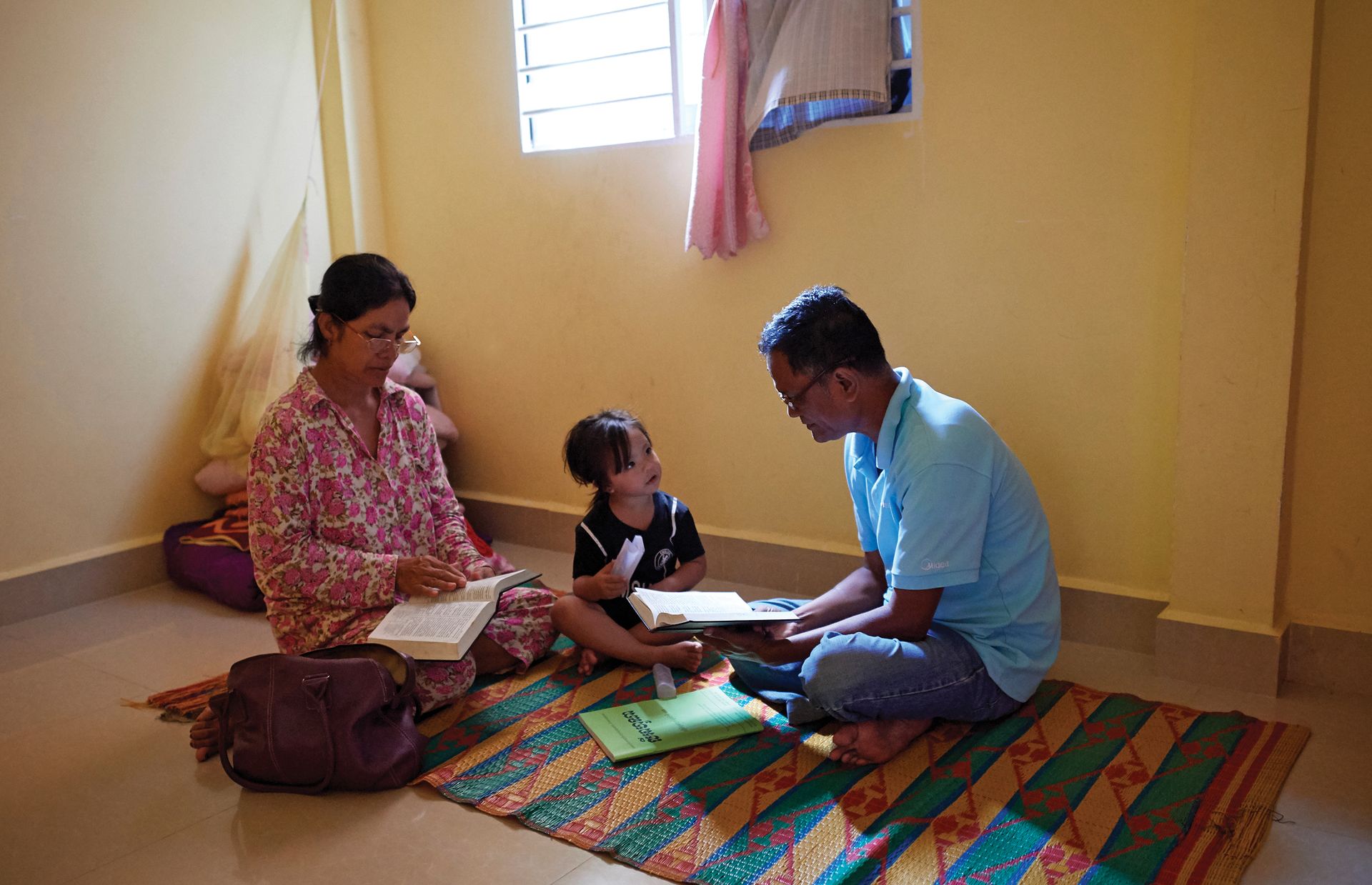 Phan Phon and his wife make sure they teach the gospel to their grandchildren. The gospel of Jesus Christ helped their family move forward after the tragedy of losing their home in a fire.