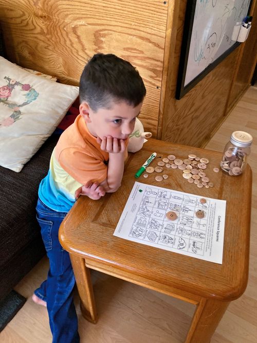 Joshua is sitting at a table with a puzzle from the firend