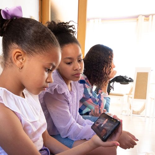 Church members watching general conference on a phone