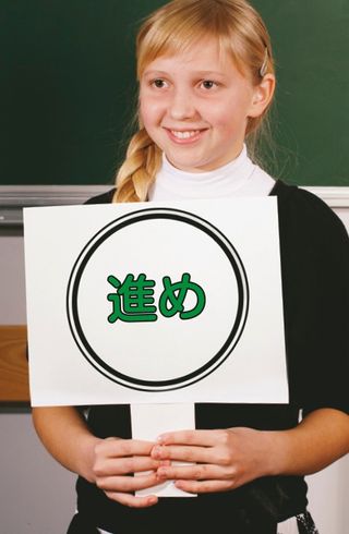 girl standing in front of chalkboard