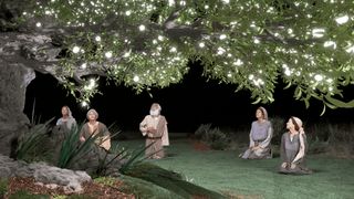 people kneeling at the tree of life