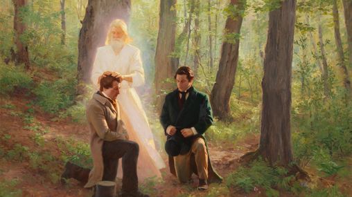 John the Baptist laying his hands on a kneeling Joseph Smith conferring the Aaronic Priesthood on him.  Oliver Cowdery is kneeling with him. They are in a grove of trees.
