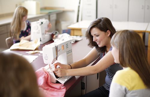 high school sewing class full of young women