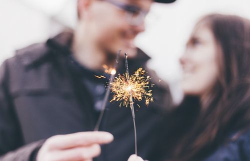 Couple holding sparklers