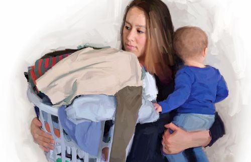 mother holding laundry basket and baby