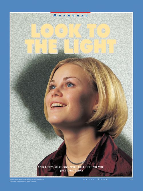 A conceptual photograph of a girl smiling and looking up with her shadow looking down in the background, paired with the words “Look to the Light.”