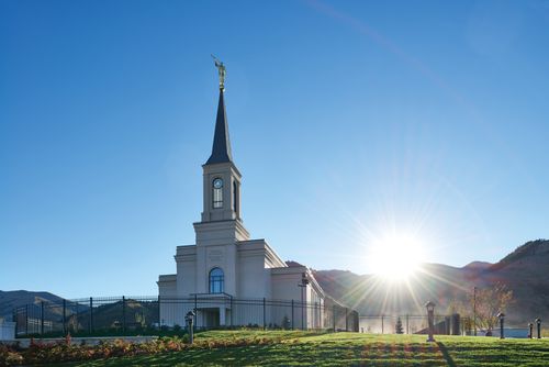 The exterior of the Star Valley Wyoming Temple with the sun shining from behind.