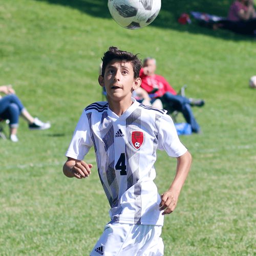 young man playing soccer