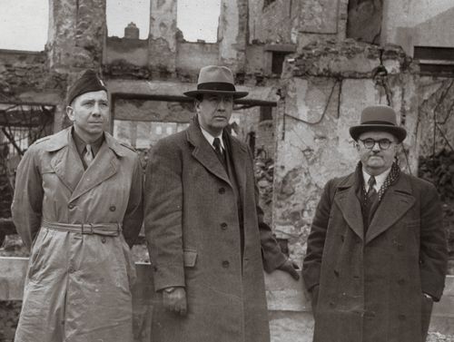 Chaplain Howard C. Badger, Ezra Taft Bensonand Max Zimmerin Freiberg, Germany. Caption: "'Man's mighty cities lie in ruins, yet the faith of the Saints is even stronger than before teh war... -Karlsruhe-"