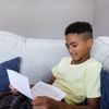 young man reading his patriarchal blessing