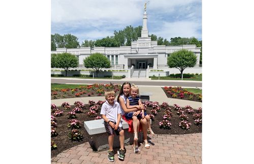 siblings sitting in front of temple