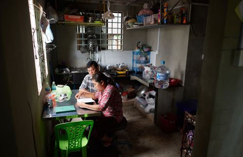 husband and wife reading together at a table