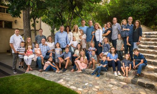 Rebecca Mehr, with her family, take a large family portrait together..