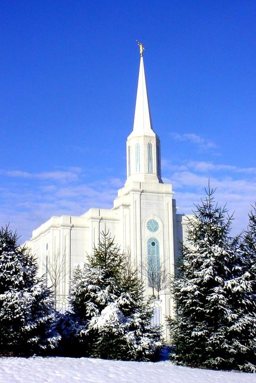 The front of the St. Louis Missouri Temple, with trees in front covered in snow in the winter.