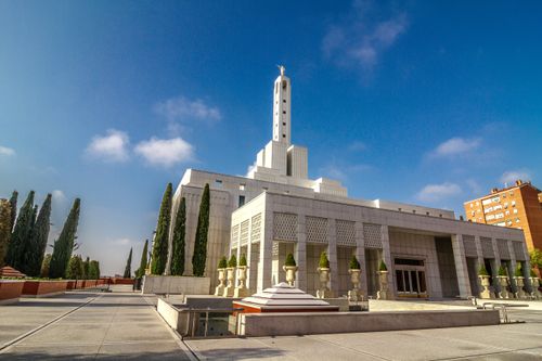 The exterior and grounds of the Madrid Spain Temple on a sunny day.