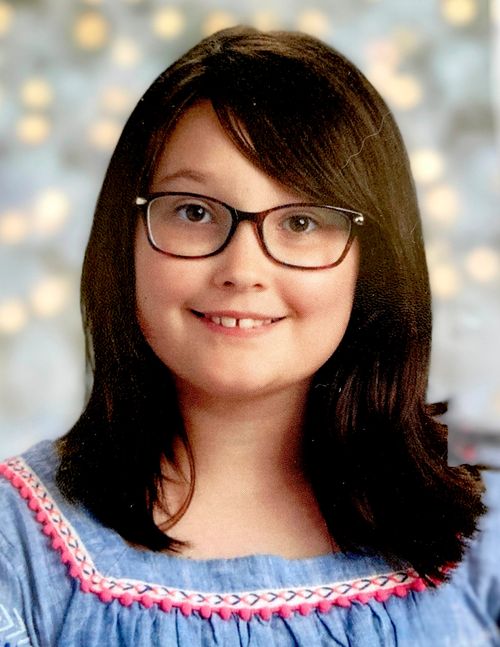 Headshot of smiling girl with glasses