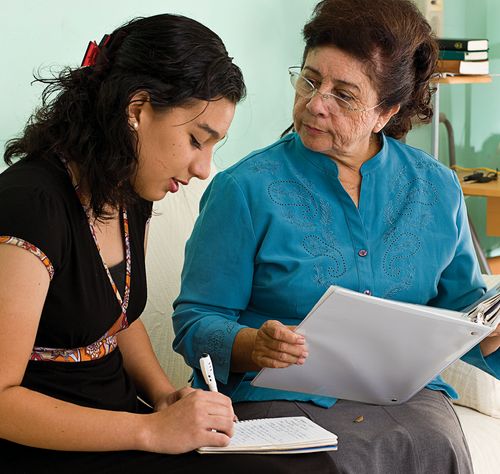 grandmother and granddaughter studying