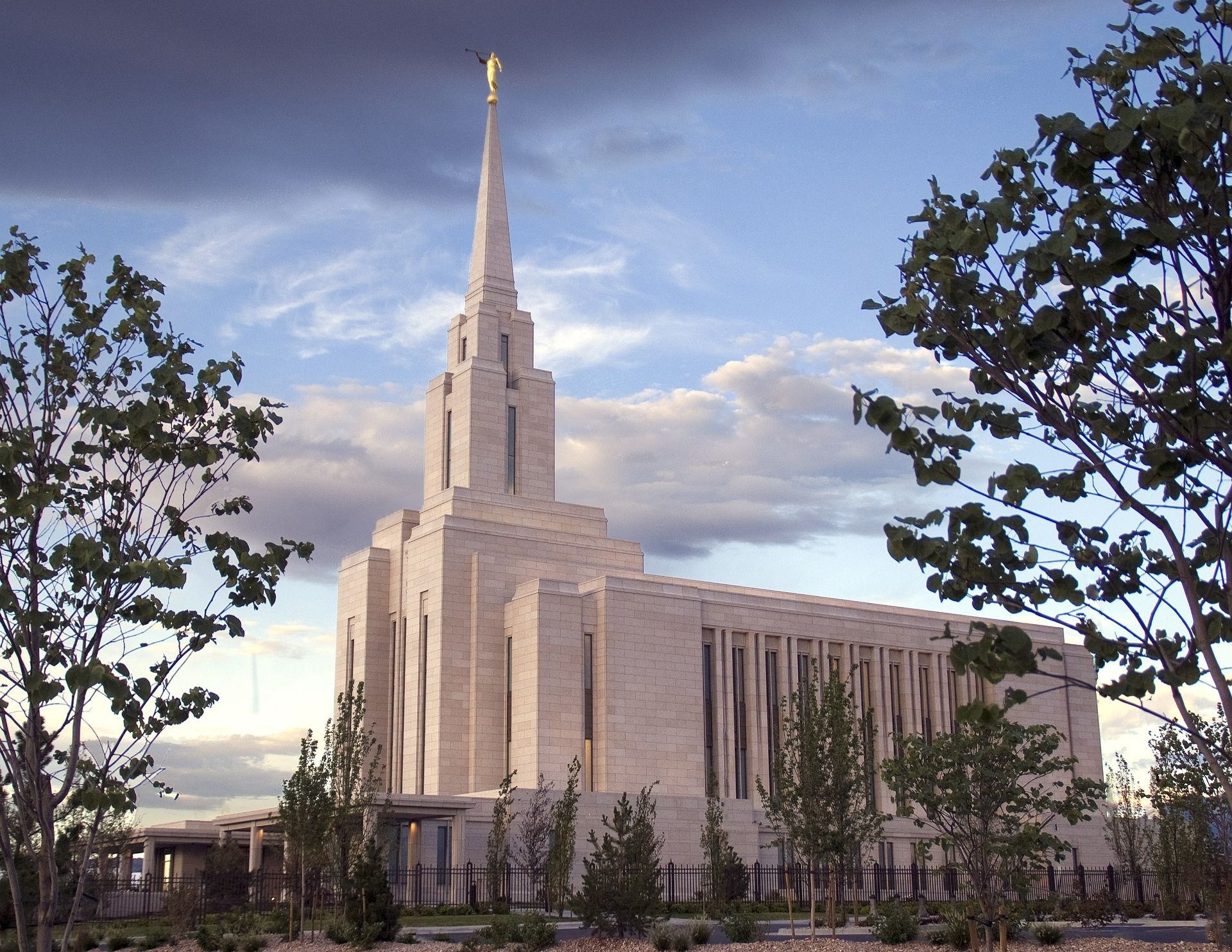 The Oquirrh Mountain Utah Temple side view at sunset, including the entrance and scenery.