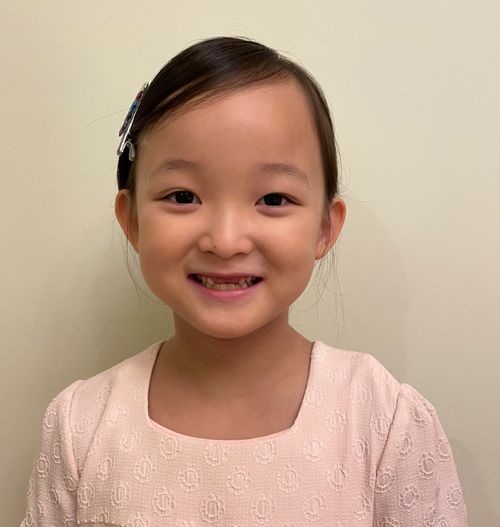 Photo of Heewon Chung in a pink dress smiling.