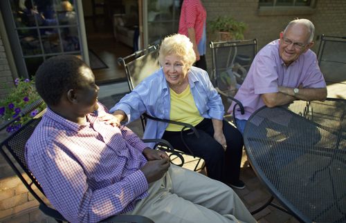 man and woman talking to younger man