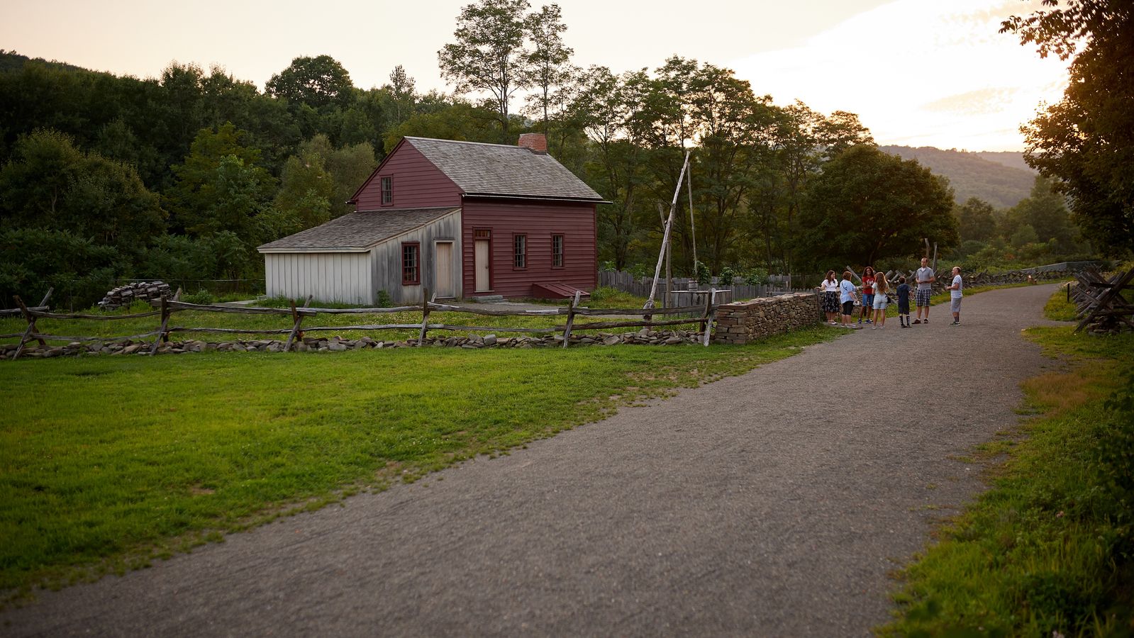 An exterior shot of farm houses in Waterloo, New York.There are trees and paths all along the way.