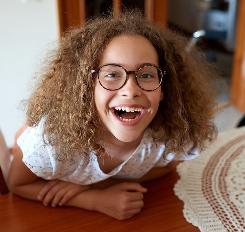 excited young girl with glasses