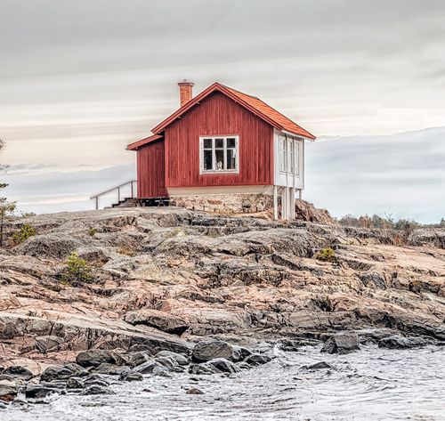 red house by ocean