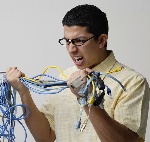 frustrated man holding cords