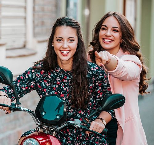 two women riding moped