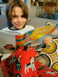 boy holding Friend magazine