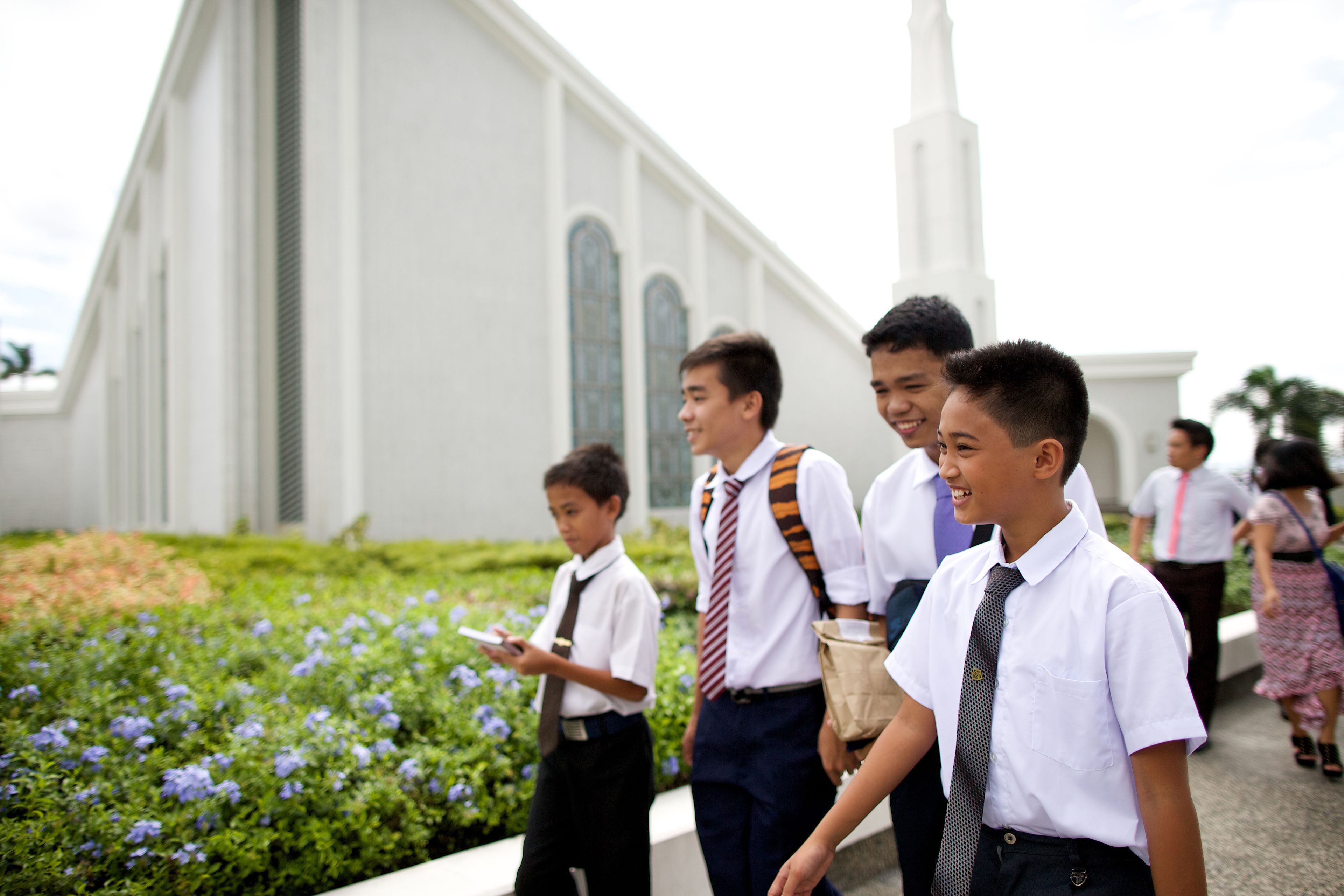 Young men walking outside of the Manila Philippines Temple.