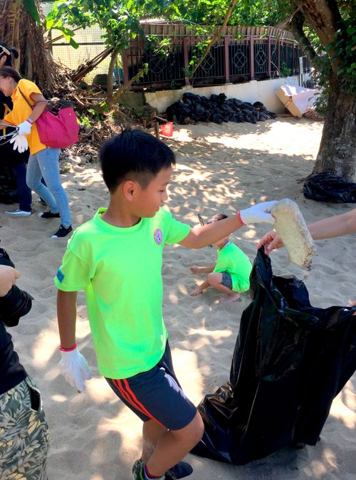 Jun Lee helps pick up trash during a service project in Korea.