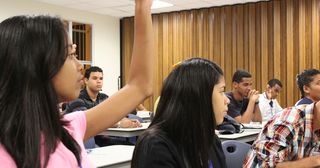 student raising hand to ask a question