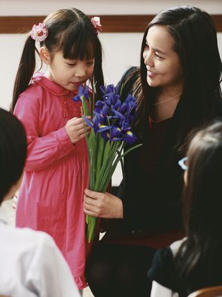 young girl looking at bouquet of flowers