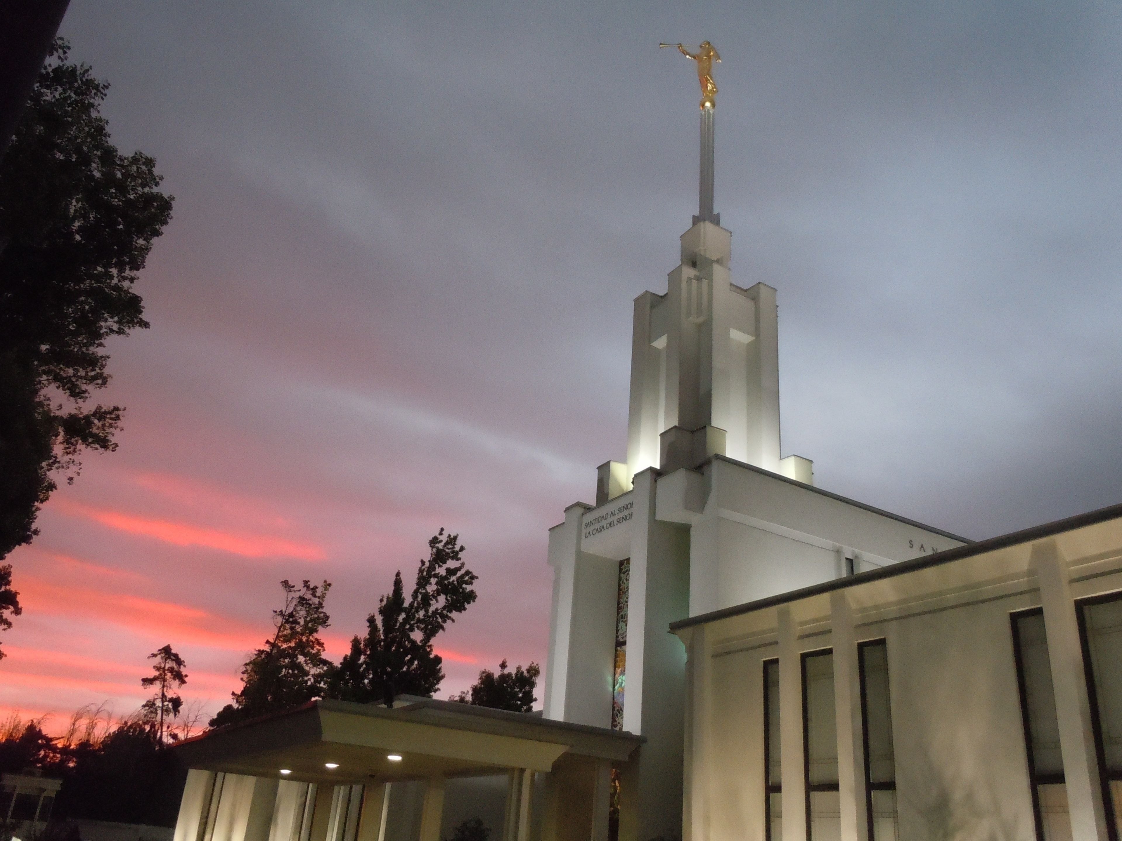 The Santiago Chile Temple in the evening, including the entrance and spire, with scenery.