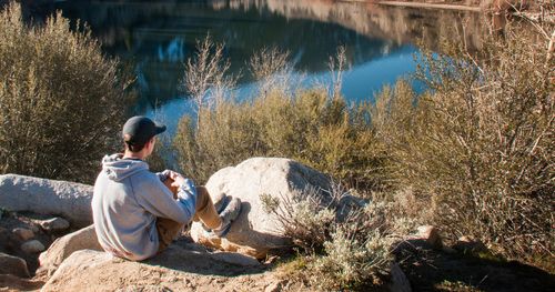 young man looking at lake