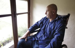 man sitting next to window