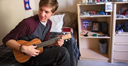 Young man playing ukulele