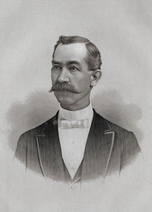 A portrait of Lorenzo Snow’s father, Oliver Goddard Snow, with a mustache, wearing a white shirt, bow tie, and black suit.